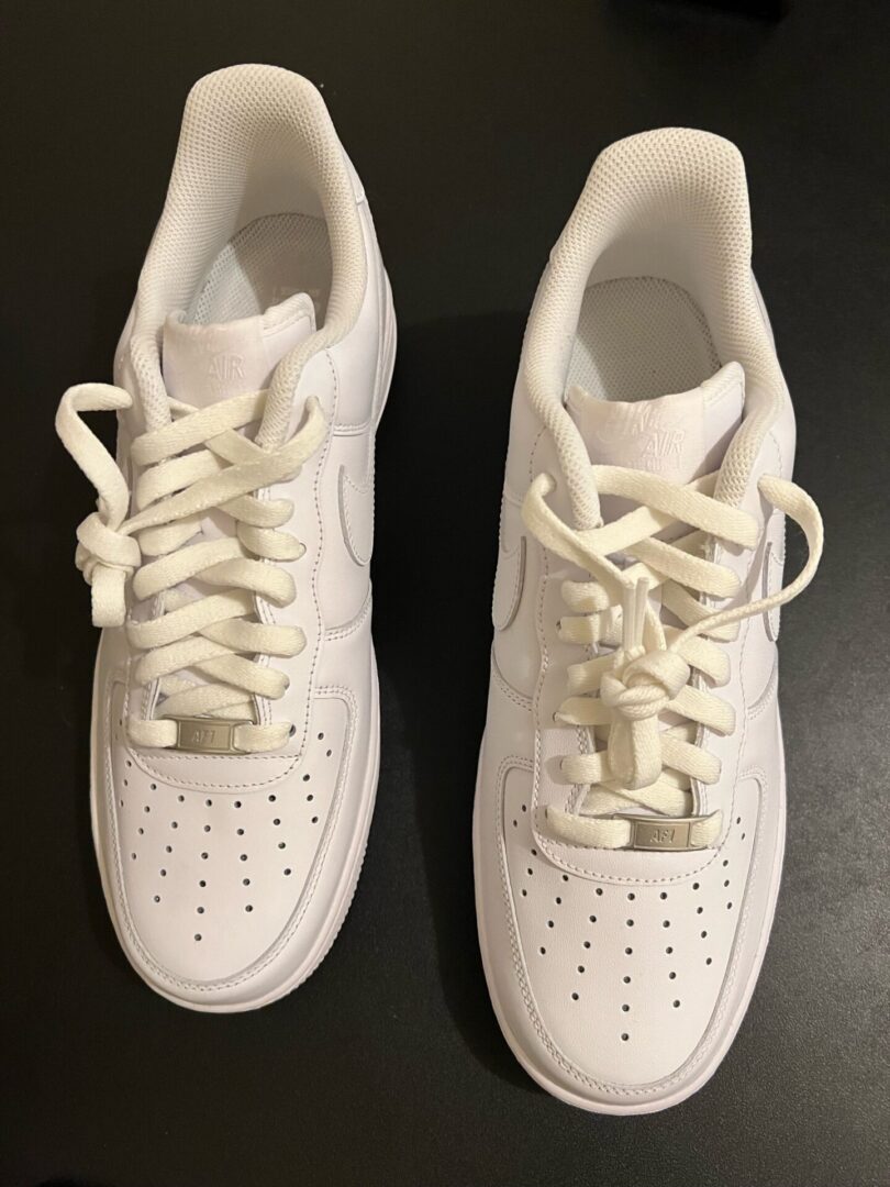 A pair of white sneakers sitting on top of a table.