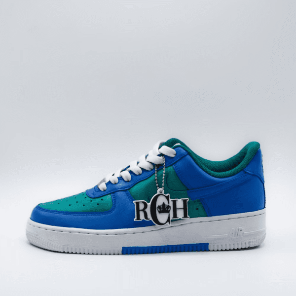 A pair of blue and green sneakers with the letters rch on them.