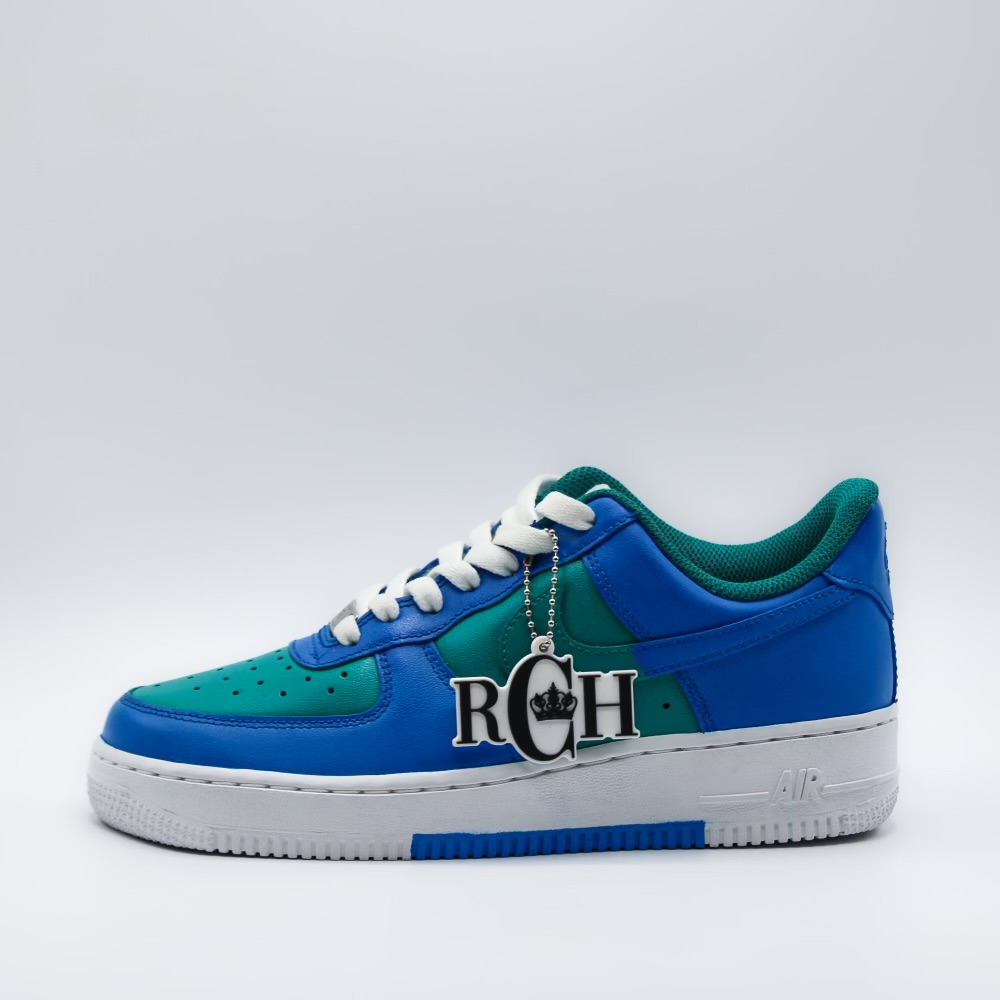 A pair of blue and green sneakers with the letters rch on them.