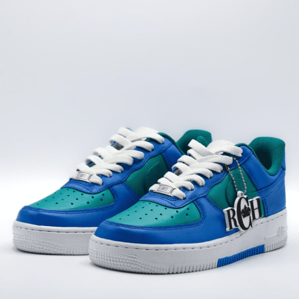 A pair of blue and green sneakers on top of a white surface.